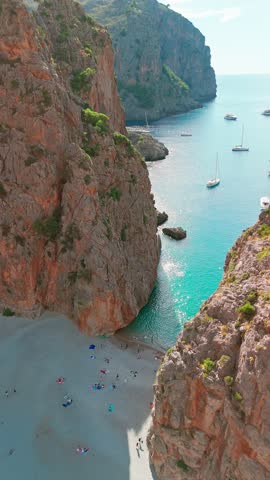 Aerial view of Sa Calobra Beach in Mallorca, Balearic Islands, Spain. Stunning hidden beach nestled between towering cliffs with crystal-clear turquoise waters, a popular summer destination on Majorca