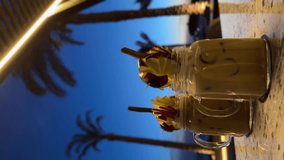 Two coffee drinks on a rustic wooden table. One is with latte art, the other is an iced latte with ice cubes. Two Cups of Coffee on a Wooden Table, Latte and Iced Latte - Powered by Shutterstock - Get 15% off with code: PIKWIZARD15