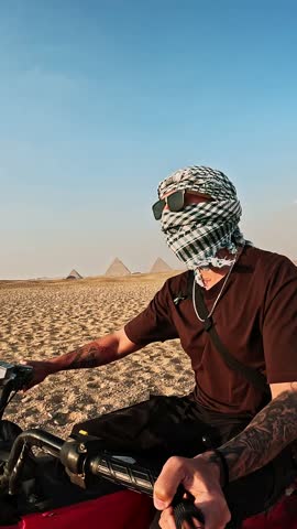 Tourist riding quad bike near giza pyramids