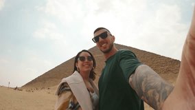 Tourists couple taking selfies at the red pyramid - Powered by Shutterstock - Get 15% off with code: PIKWIZARD15