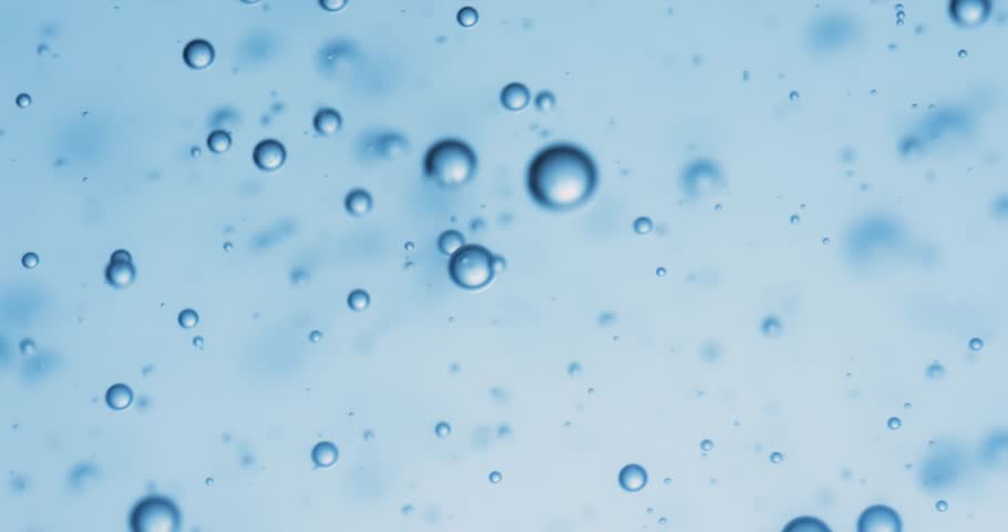 Many water bubbles in blue water close up, abstract water wave with bubbles in slow motion.