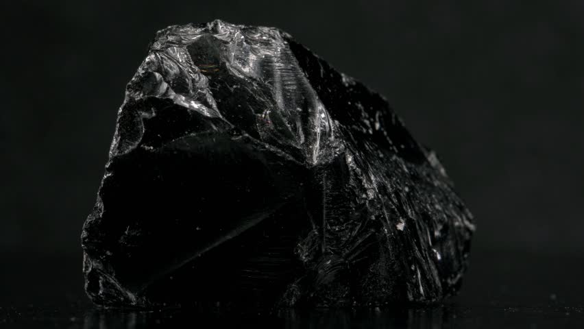 Black Obsidian (Natural volcanic glass - from Mexico) sample rotating against a black background