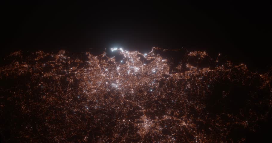 San Juan (Puerto Rico) aerial view at night. View on modern city from space. Camera is zooming in, rotating counterclockwise