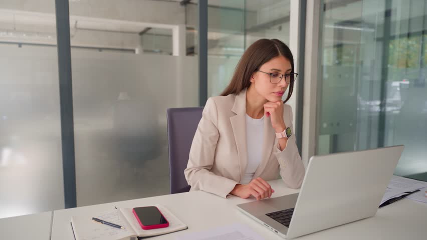 Focused middle aged business woman using laptop at work in office. Professional female executive entrepreneur in suit working on computer pc at company workplace, doing financial analyze. Copy space - Powered by Shutterstock - Get 15% off with code: PIKWIZARD15