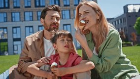 Child parents eating cold ice cream cone in outdoor picnic closeup. Young mother father and small boy enjoying sweet dessert at sunshine green nature together. Summer holidays entertainment concept  - Powered by Shutterstock - Get 15% off with code: PIKWIZARD15
