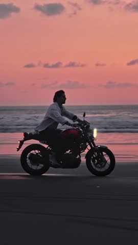 Man Riding Bike in Summer Landscape of Beach Traveling in Outdoors Nature. Handsome Motorcyclist or Surfer Driving Motorcycle in Speed Shot. Lifestyle of Alone Man in Motion on Stylish Transport