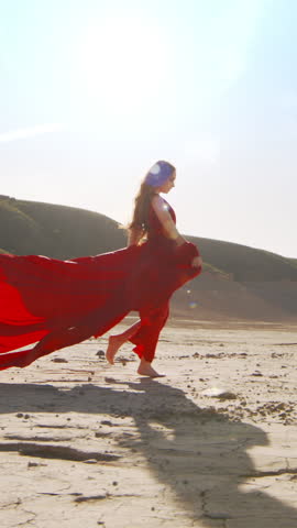 Vertical Slow-motion. Passion Redhead Woman in Red Blowing Dress Run with Dramatic Landscape. Concept of Girl Power, Freedom, Strong, Independence, Feminism, Self-Development