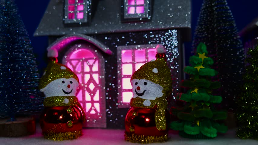 Evening Christmas atmosphere around the house, snowmen and Christmas trees