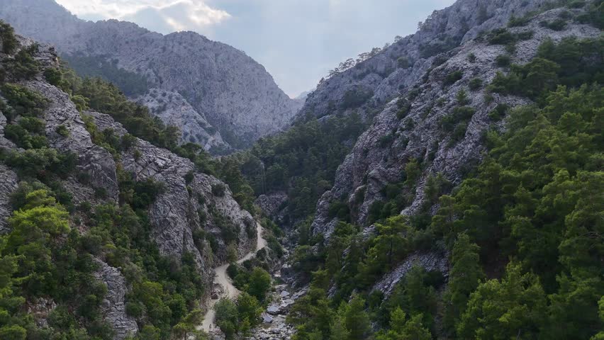 Drone Flying Over Mountain Gorge with Dirt Road