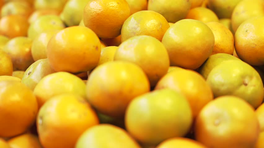 Close-up of a pile of yellow tangerines