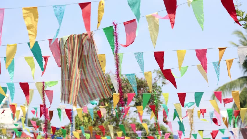 Colorful Triangle Flags Dancing in the Breeze Against a Clear Sky