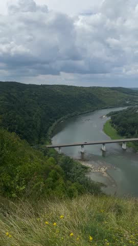 Scenic River Valley with Bridge and Lush Green Banks