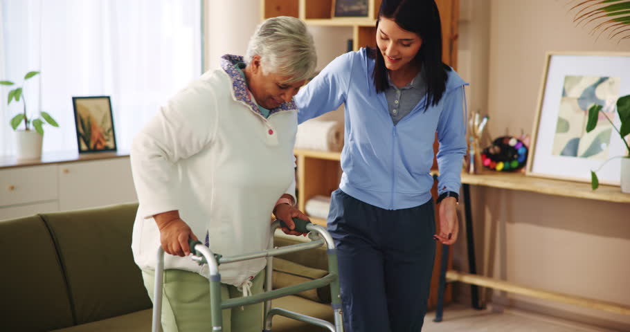 Senior woman, volunteer and helping with walker of balance support, rehabilitation and walking stability. Caregiver, mobility aid and elderly person with disability, treatment and healthcare at house
