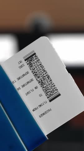 Close-up. woman holds air tickets and passports in her hands against the backdrop of empty check-in counters at the airport. Travelling by airplane.