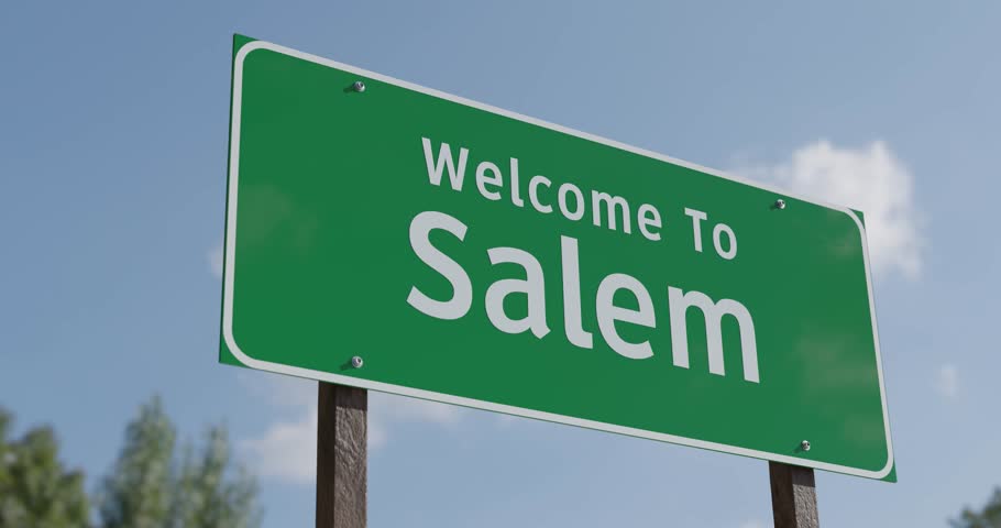 Driving By A Welcome To Salem, Oregon Green Road Sign Against a Blue Sky and Clouds - United States Capital Series.