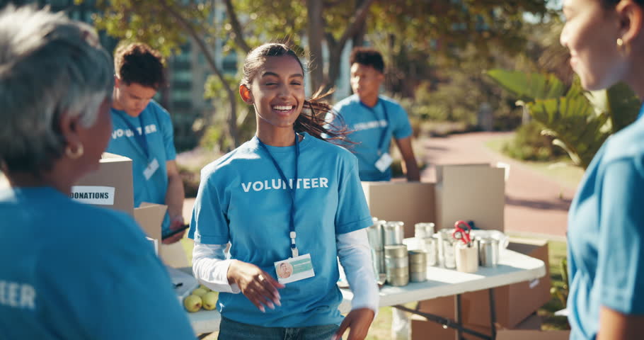 Volunteer, people and high five with success outdoor for charity event, ngo programme and community project. Donation outreach, women and applause for food drive achievement and social responsibility