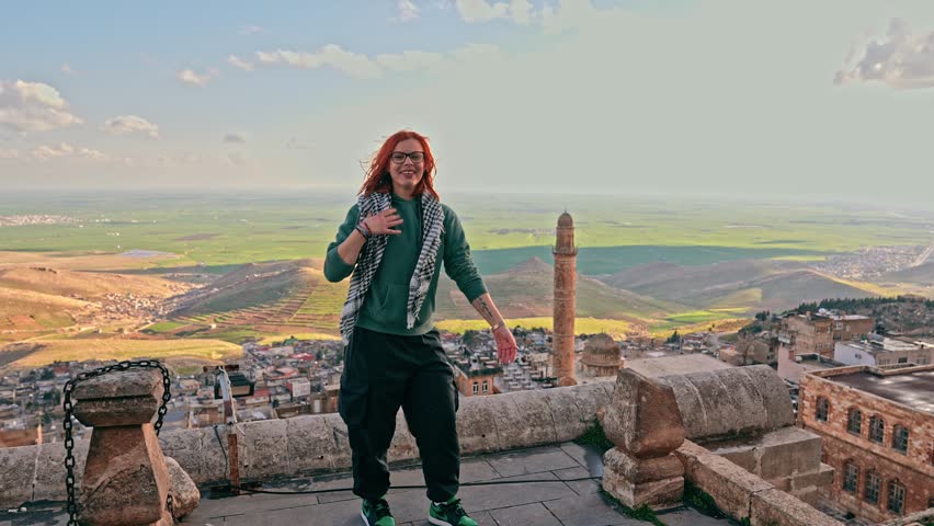 Female Tourist Gesturing Towards Mardin View and Expressing Her Visit