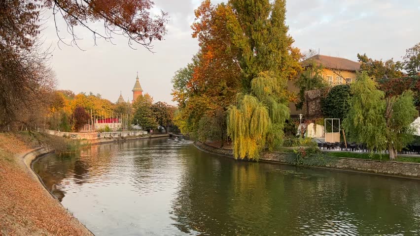 kayaking on a river, in autumn, with a beautiful Cathedral in background