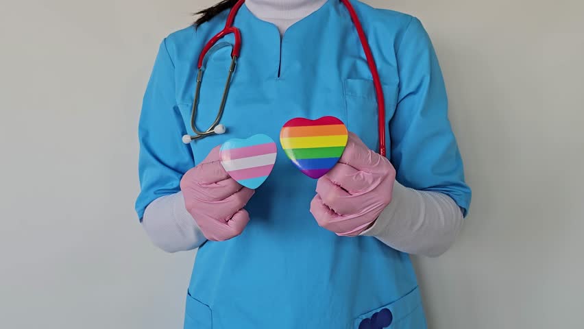 Healthcare worker showcases support for LGBTQ LGBT community with heart symbols in a clinic