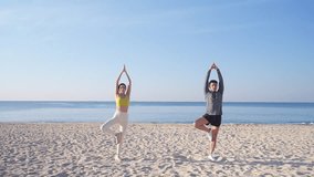 Healthy Asian man and woman in sportswear practicing yoga exercise stretching body at the beach. Couple enjoy outdoor active lifestyle do sport training fitness workout. Healthcare wellness motivation - Powered by Shutterstock - Get 15% off with code: PIKWIZARD15