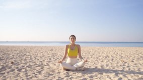 Healthy Asian woman in sportswear practicing yoga exercise meditation at the beach. People enjoy outdoor active lifestyle do sport training fitness workout at seaside. Healthcare wellness motivation. - Powered by Shutterstock - Get 15% off with code: PIKWIZARD15