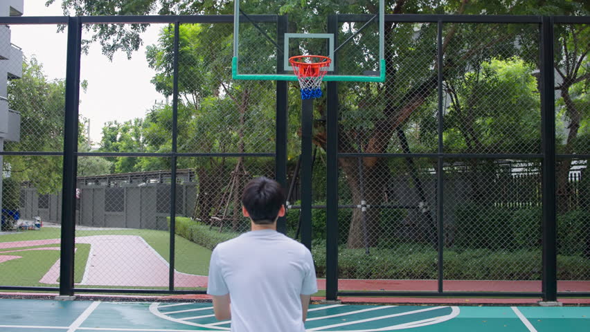 Basketball Player Shooting on Outdoor Court