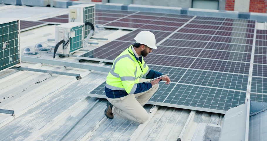 Engineering, man and tablet with solar panel on rooftop for renewable energy installation and quality assurance. Power supply service, technician and inspection of photovoltaic grid for maintenance