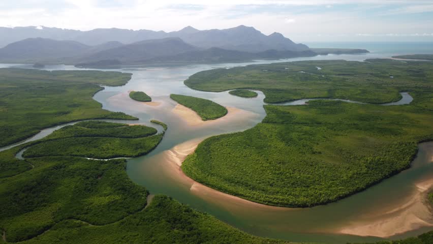 Pristine Beautiful Australian Coastal Landcape with mangroves, rivers and islands - Hinchinbrook Island Nationalpark from Above with blue sky