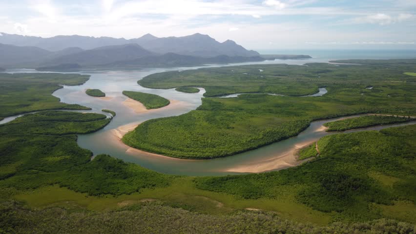 Pristine Beautiful Australian Coastal Landcape with mangroves, rivers and islands - Hinchinbrook Island Nationalpark from Above with blue sky