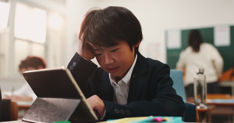 Boy, tablet and kid stress in class, online and frustrated with digital quiz or assignment. Male person, adhd and mental burnout at school in Japan, elearning and tired of education or brain fog