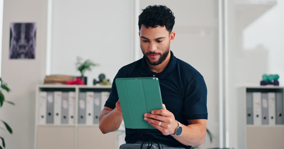 Smile, man and physiotherapist with tablet in office for medical research, orthopedic report and wellness. Person, digital and scroll with healthcare results, planning schedule and online appointment