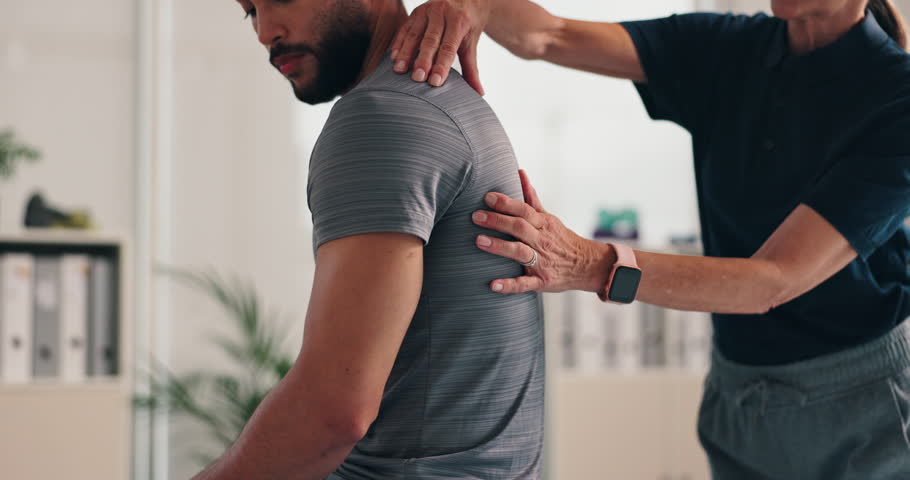 Consultation, physiotherapist and massage man for back pain with shoulder injury treatment and rehabilitation. Patient, professional hands and bone assessment for osteoporosis and physical therapy