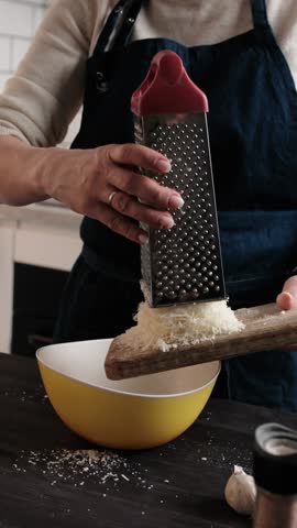 Girl Chef Grating Hard Parmesan Cheese And Then Sprinkling The Grated Cheese For Sauce Preparation, Vertical Video