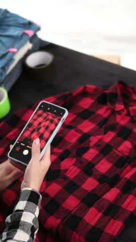 Girl Takes Photos With Smartphone For Online Selling Shirt Board For Pre-Owned Clothing, Vertical Video