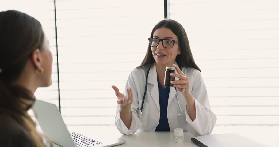 Doctor in uniform hold pill bottle explaining medication precautions or treatment instructions to patient, give dosage instructions, possible side effects, expected results. Prescription, medical care
