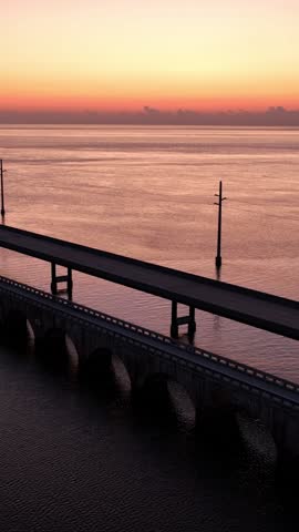 Aerial shot of the Seven Mile Bridge in Florida just before sunrise. The bridge connects the Florida Keys on the way to Key West. Vertical Video.