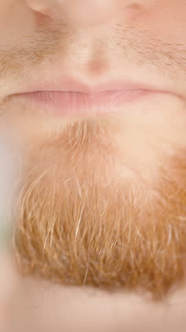 Vertical video. Close-Up of a Bearded Man Drinking Green Liquid from a Small Transparent Cup for Oral Care Treatment Mouthwash Usage for Gum and Teeth Treatment