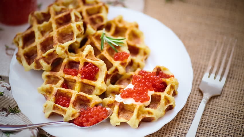Homemade potato waffles with caviar and herbs for breakfast