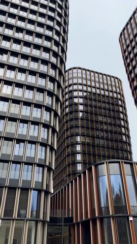 Modern Architectural, Geometric Skyscrapers with Unique Facades Against Gray Sky, Showcasing Urban Innovation and Stunning Design in Metropolises, High-rise buildings