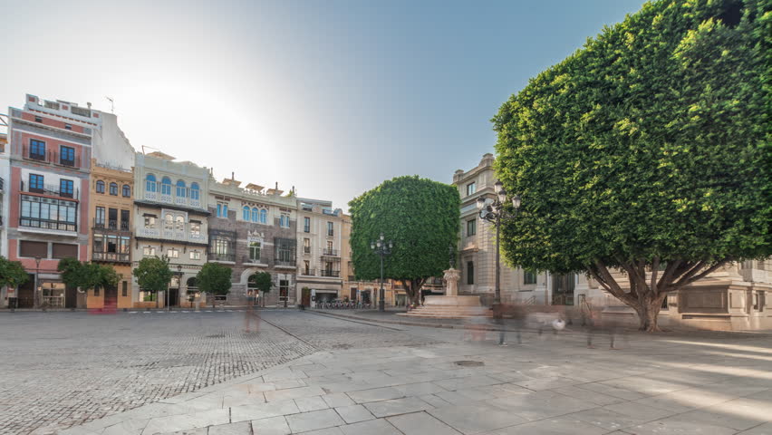 Panorama showing Avda. de la Constitucion, major avenue in Casco Antiguo district of Seville, Spain. Timelapse hyperlapse with Edificio de la Adriatica, historical buildings and passing trams