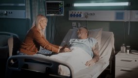 Hospital scene shows old man in bed and woman sitting beside bed holding hands. Smiling adult daughter gives support and care to ill father in clinic - Powered by Shutterstock - Get 15% off with code: PIKWIZARD15