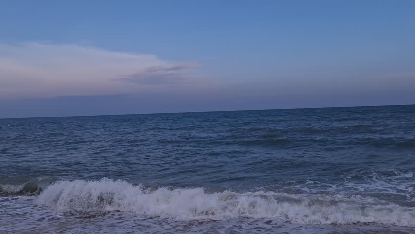 The beautiful Cha-am beach in Thailand, with strong and cool waves, beautiful blue sea when it crashes against the fine sandy beach. Although it is not sparkling, it has a soft and deep quality that i