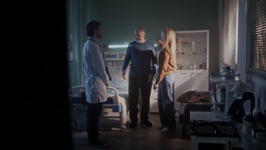 Patient shakes hands with doctor hugging woman and takes bag getting ready to go home. Happy family receives discharge for elderly man and thanks doctor