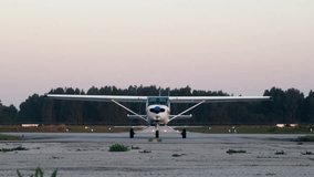 A small propeller training high wing airplane taxiing along the airport taxiway after landing after a training flight during a beautiful sunset light - Powered by Shutterstock - Get 15% off with code: PIKWIZARD15