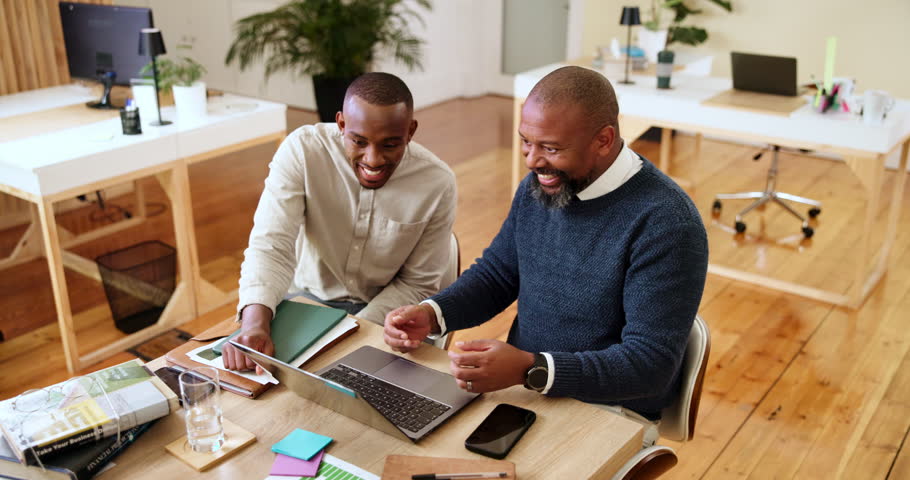 Meeting, office and black people with good news on laptop for article feedback, writing advice or review. Publishing, magazine agency and editor with writer on tech to celebrate, fist pump or success