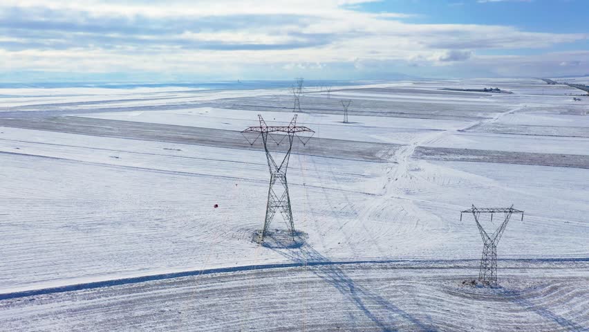 Image of a power transmission line taken in a snowy area.