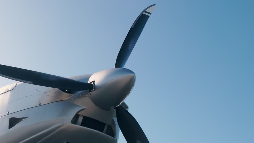 Starting the engine of a propeller single-engine light aircraft. Blades starts to rotate. - Powered by Shutterstock - Get 15% off with code: PIKWIZARD15