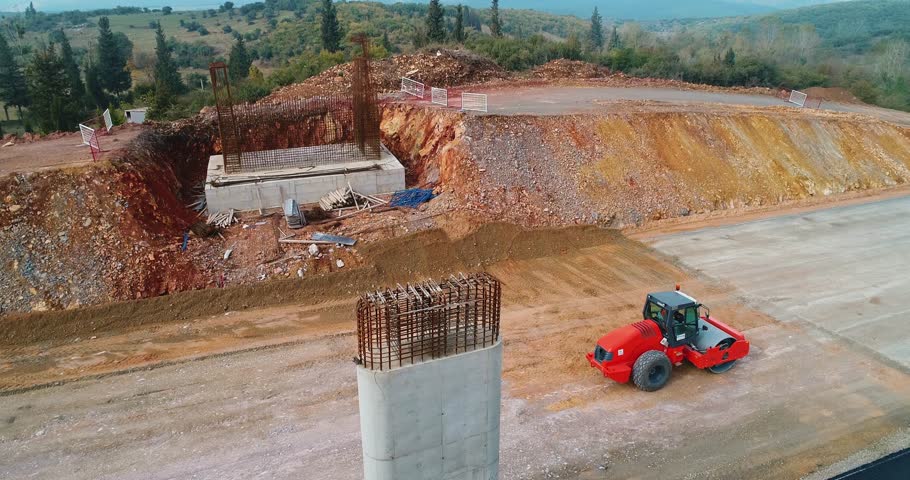 Bridge Foundation Construction with Roller Compactor in Foreground | Civil Engineering Project Aerial View
