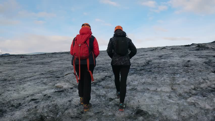 Explorer people are climbing on the top of glacier with ice and volcanic ash in Iceland