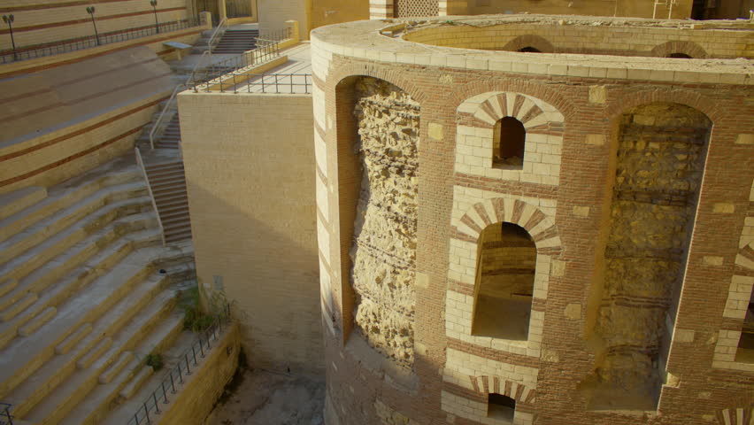 Tilt shot of a historical landmark in Cairo, Egypt. South gate of Babylon Fortress in Old Cairo with residential neighborhood visible in the background.